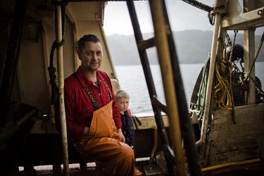 Fisherman Peter Campbell with his 7 year old son Gregor on a boat on the River Clyde. The Campbell family have been langoustine fishermen for three generations on the river and surrounding sea lochs.