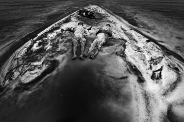Men lie in mineral rich black mud to treat their skin at Lake Urmia, a salt lake in the province of West Azerbaijan. The salt and mineral laden mud are reputed to have healing properties for skin and...