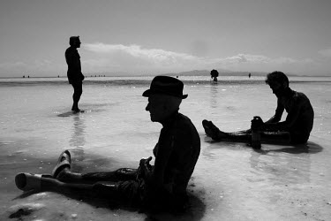 Men use mineral rich black mud to treat their skin at Lake Urmia, a salt lake in the province of West Azerbaijan. The salt and mineral laden mud are reputed to have healing properties for skin and rhe...