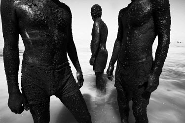 Men use mineral rich black mud to treat their skin at Lake Urmia, a salt lake in the province of West Azerbaijan. The salt and mineral laden mud are reputed to have healing properties for skin and rhe...
