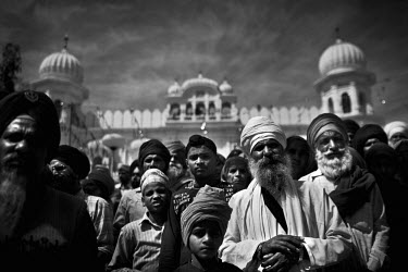 Men and boys gather in front of a Sikh temple at the Hola Mohalla Festival. It takes place on the first day of the lunar month of Chet (March/April).