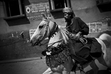 A man rides an ornately decorated horse at the Hola Mohalla Festival. It takes place on the first day of the lunar month of Chet (March/April).