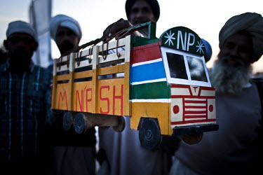 A man carrying a toy bus arrives at the Hola Mohalla Festival. It takes place on the first day of the lunar month of Chet (March/April).