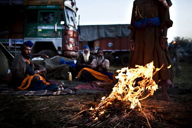 Attendees at the Hola Mohalla Festival gather around a camp fire. It takes place on the first day of the lunar month of Chet (March/April).