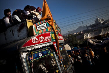 Sikhs arrive by bus to attend the Hola Mohalla Festival. It takes place on the first day of the lunar month of Chet (March/April).