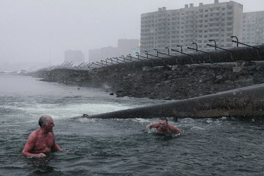 Men swim in the river in Norilsk, a resource-rich city in Siberia above the Arctic Circle.