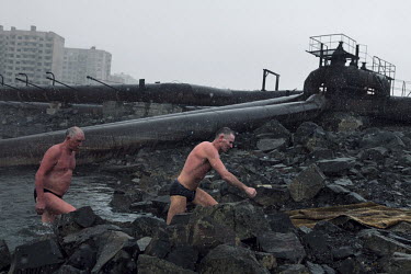 Men get out of the river after a swim in Norilsk, a resource-rich city in Siberia above the Arctic Circle.