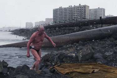 A man gets out of the river after a swim in Norilsk, a resource-rich city in Siberia above the Arctic Circle.