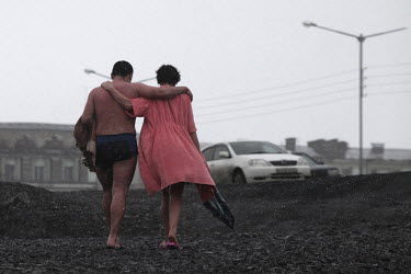 A couple return to their car after swimming in the river in Norilsk, a resource-rich city in Siberia above the Arctic Circle.