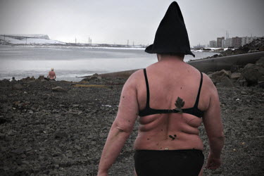 A woman heads towards the river to go swimming in Norilsk, a resource-rich city in Siberia above the Arctic Circle.