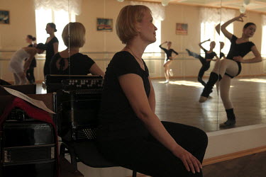 A teacher watches students practice at a ballet school in Norilsk, a resource-rich city in Siberia above the Arctic Circle.