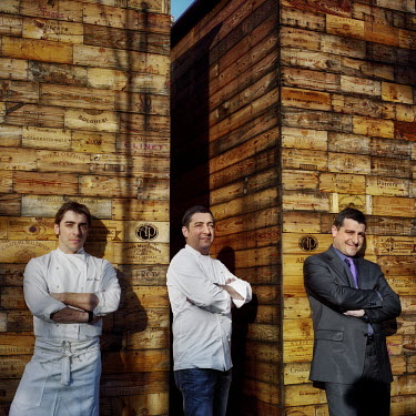 The Roca brothers (Jordi, the dessert chef, left; Joan, the main chef, centre; and Josep, the sommelier and maitre d', right) stand in front of stacked used wine boxes. Together they run El Celler de...