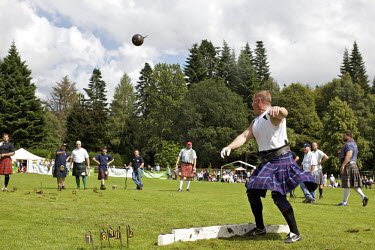 Neil Elliott throws a weight in an event at the Inveraray Highland Games, held at Inveraray Castle in Argyll.