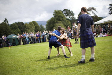 Men compete in the backhold wrestling event at the Inveraray Highland Games, held at Inveraray Castle in Argyll.