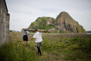 Neil Elliott and his friend carry a caber near Dumbarton. Neil competes in over 40 Highland Games and heavyweight events across the world throughout the summer.