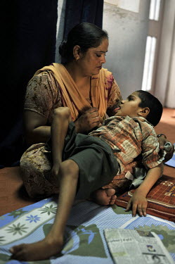 11 year old Nirmal Singh who has birth defects is held by his mother in the waiting room of the privately funded Baba Farid Centre in Faridkot. An increasing and ignored percentage of children are bei...