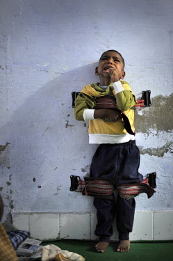 4 year old Akriti who has cerebral palsy cries as he is strapped to a wall to help straighten his limbs at the privately funded Baba Farid Centre in Faridkot. An increasing and ignored percentage of c...