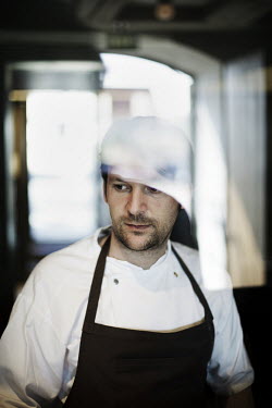 Chef Rene Redzepi works in the kitchen of his two Michelin star restaurant Noma, which was voted the best restaurant in the world in 2010.