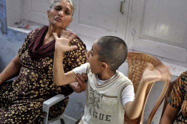 A child with birth defects sits with his mother in the waiting room of the privately funded Baba Farid Centre in Faridkot. An increasing and ignored percentage of children are being born suffering the...