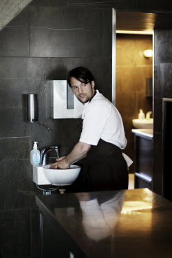 Chef Rene Redzepi washes his hands in a sink in the kitchen of his two Michelin star restaurant Noma, which was voted the best restaurant in the world in 2010.