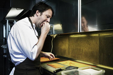 Chef Rene Redzepi tastes some cheese he is cooking with in the kitchen of his two Michelin star restaurant Noma, which was voted the best restaurant in the world in 2010.