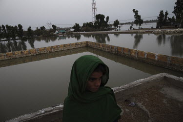 A girl seeks refuge on the roof of a school near Karampur. Severe flooding had left at least 1,600 people dead and affected up to 20 million.