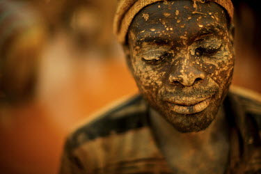 A miner has his face spattered with mud from working in a small scale gold mine. Thousands of Zimbabweans have crossed into neighbouring Mozambique in search of work, and many have turned to gold mini...