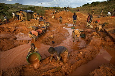 Men pan for gold in a small scale mine. Thousands of Zimbabweans have crossed into neighbouring Mozambique in search of work, and many have turned to gold mining.
