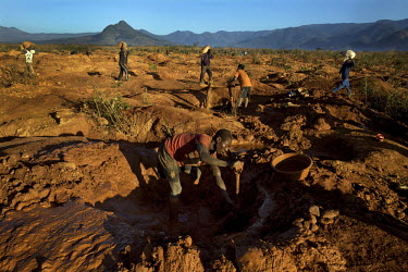 A man digs out the overburden in a small scale gold mine. Thousands of Zimbabweans have crossed into neighbouring Mozambique in search of work, and many have turned to gold mining.