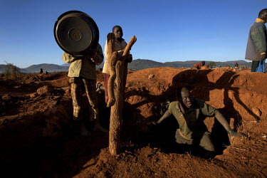 A man emerges from a hole dug in a small scale gold mine. Thousands of Zimbabweans have crossed into neighbouring Mozambique in search of work, and many have turned to gold mining.