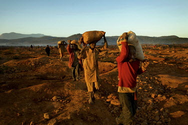 Men carry supplies to a small scale gold mine. Thousands of Zimbabweans have crossed into neighbouring Mozambique in search of work, and many have turned to gold mining.
