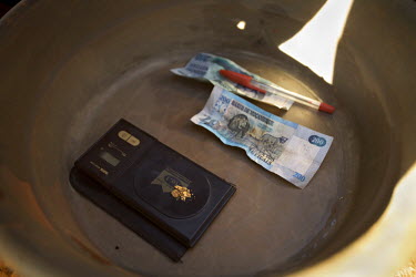 Grains of gold are weighed at a small scale gold mine. Thousands of Zimbabweans have crossed into neighbouring Mozambique in search of work, and many have turned to gold mining.