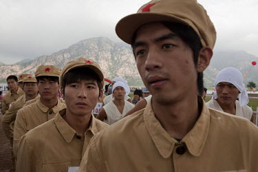 Competitors dressed in PLA (People's Liberation Army) revolutionary era outfits wait for their event in the Red Games. Held in Junan County, this sporting event is a nostalgic tribute to the communist...