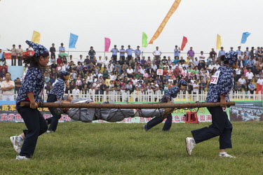 Female competitors dressed as revolutionary volunteers carry 'wounded soldiers' on stretchers in the 'Rescue the Wounded Soldier' event of the Red Games. Held in Junan County, this sporting event is a...
