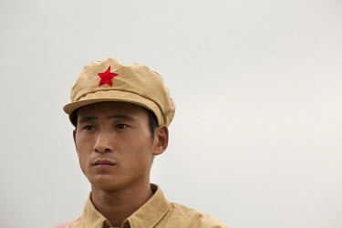 A competitor dressed in a PLA (People's Liberation Army) revolutionary era outfit participates in the Red Games. Held in Junan County, this sporting event is a nostalgic tribute to the communist era.