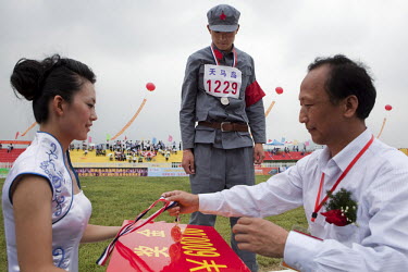 Senior officials present event winners with medals and winners cheques at the Red Games. Held in Junan County, this sporting event is a nostalgic tribute to the communist era.