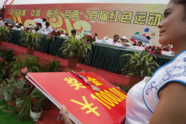 Hostesses wait to hand over medals and winners cheques to competitors at the Red Games. Held in Junan County, this sporting event is a nostalgic tribute to the communist era.