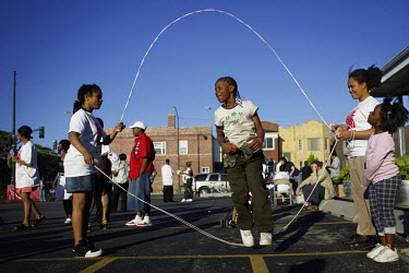 Girls skip at a CeaseFire sponsored community barbecue and dance competition on the West Side of Chicago. CeaseFire takes a public health approach to preventing gun violence in Chicago's roughest neig...