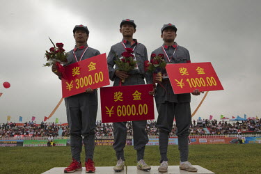 Winning competitors dressed in PLA (People's Liberation ARmy) revolutionary era outfits receive their prizes on the podium at the Red Games. Held in Junan County, this sporting event is a nostalgic tr...