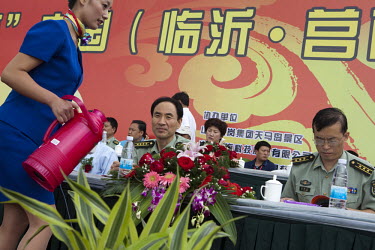 Local PLA (People's Liberation Army) officials are served tea as they watch the Red Games. Held in Junan County, this sporting event is a nostalgic tribute to the communist era.