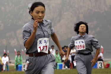Female competitors dressed in revolutionary outfits race in the 'Spinning Wheel in Ya'nan' event of the Red Games. Held in Junan County, this sporting event is a nostalgic tribute to the communist era...