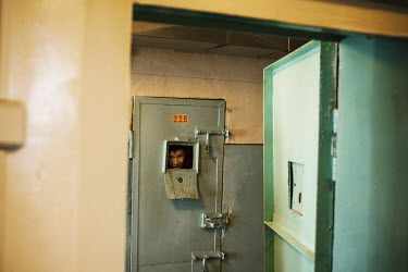 An inmate looks out from his cell on a corridor where tuberculosis (TB) patients are detained in SIZO 1, a pre-trial detention centre. Kyrgyzstan's prisons are experiencing a TB epidemic, where the in...
