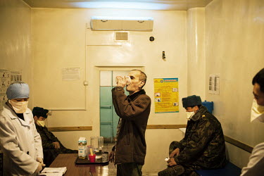 An inmate takes his oral tuberculosis (TB) treatment at SIZO 1, a pre-trial detention centre. All medical staff and guards wear masks as many of the detainees have MDR TB (multi-drug-resistant tubercu...