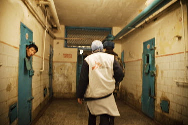 A prisoner sticks his head out of his cell as MSF (Medecins Sans Frontieres) staff walk down the corridor where tuberculosis (TB) patients are detained in SIZO 1, a pre-trial detention centre. Kyrgyzs...