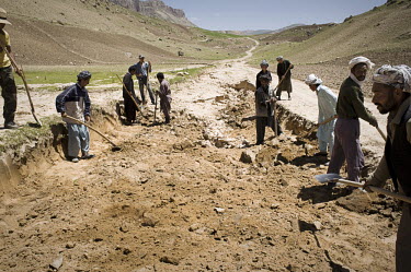 A group of farmers working on the site of a cash-for-work scheme, a short-term intervention used by humanitarian assistance organisations to provide temporary employment in public projects, such as re...
