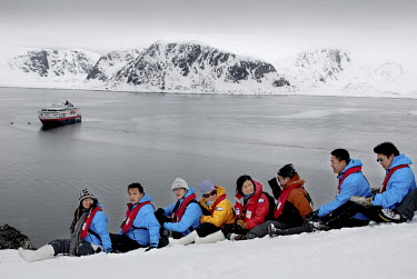 Chinese tourists pose at Ytre Norskoya on the island of Spitsbergen on Svalbard, on an outing from their trip on MS Fram.