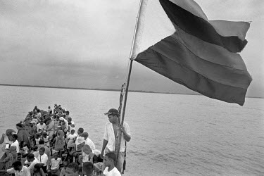 Displaced persons crossing the Gulf of Uraba by boat on their return to Cacarica where they are to found a 'Peace Community', a settlement of people who were exiled by a joint military/paramilitary of...