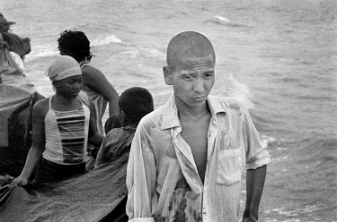 A young man travels by boat with other displaced people across the Gulf of Uraba. They are returning to Cacarica where they are to found a 'Peace Community', a settlement of people who were exiled by...