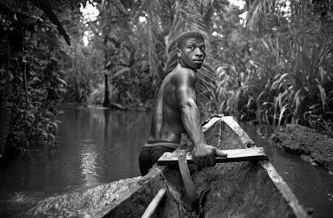 A boatman pulls his canoe along the Cacarica River towards the 'Peace Community' of Cacarica. The community is a settlement of people who were displaced by a joint military/paramilitary offensive, nam...