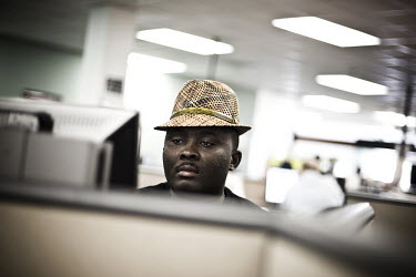 31 year old For Exil sits at a computer looking for a job at the WorkForce One centre in Hollywood, Florida. It is his first time at the job centre and he is using the computer to set up his resume. '...